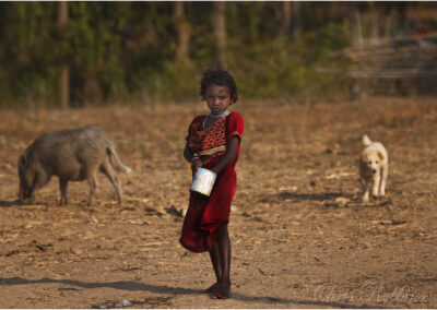 Indian,Tribal,girl,puppy,dog,Pig,boar,Kanha,feeding,Madhya,Pradesh,India,animals,national,park,travel,destinations