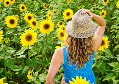 sunflower; yellow; flower; freedom; field; outdoor; people; countryside; happy; beauty; nature; summer; beautiful; smile; sun; model; pleasure; lifestyle; sunlight; landscape; young; attractive; sunny; dress; portrait; golden; happiness; fun; sunshine; health; life; wellness; emotion; summertime; dreams; person;