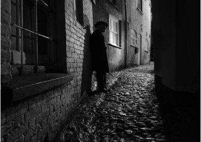 dark alley; dark; alley; black; crime; urban; architecture; city; scary; people; street; brick; mystery; man; person; silhouette; danger; thief; shadow; gangster; light; violence; fear; criminal; suspicious; male; threat; dangerous; eerie; character; hiding; stalker; exit; imagination; walk; eeriness; human; way out; adult; scene; darkness; narrow; men; stone; outdoor; night; old; town; spooky; alleyway; atmosphere; black and white